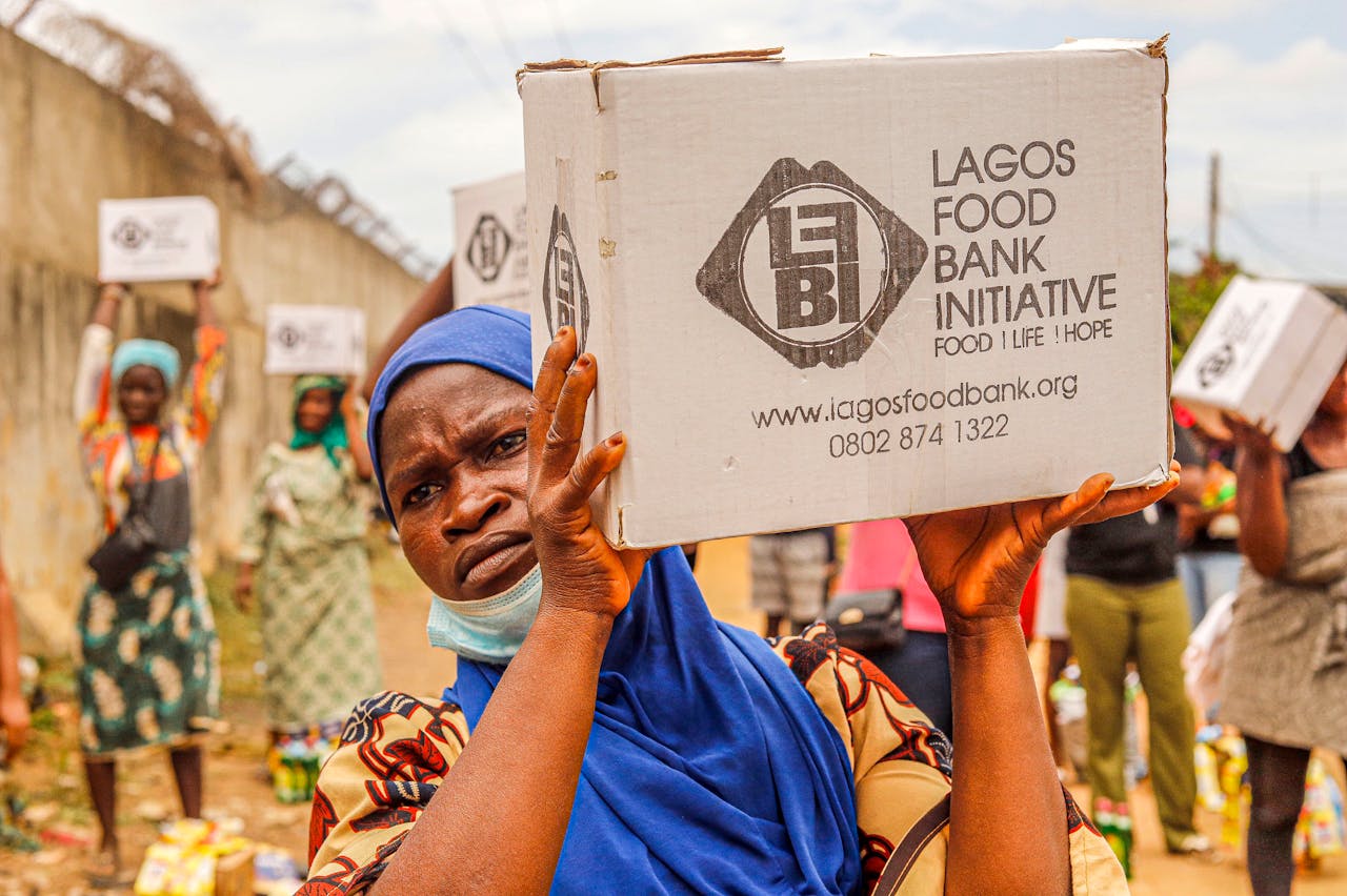 heros-img Community members engage in food distribution at Lagos Food Bank initiative event.